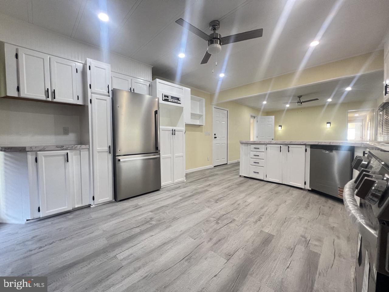 202 Mt Laurel Drive Ridgeley, WV 26753 - Photo 3 of 38 a view of a refrigerator in kitchen and wooden floor