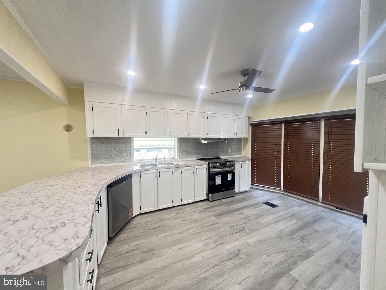 202 Mt Laurel Drive Ridgeley, WV 26753 - Photo 4 of 38 a large kitchen with stainless steel appliances granite countertop a stove a sink and a refrigerator