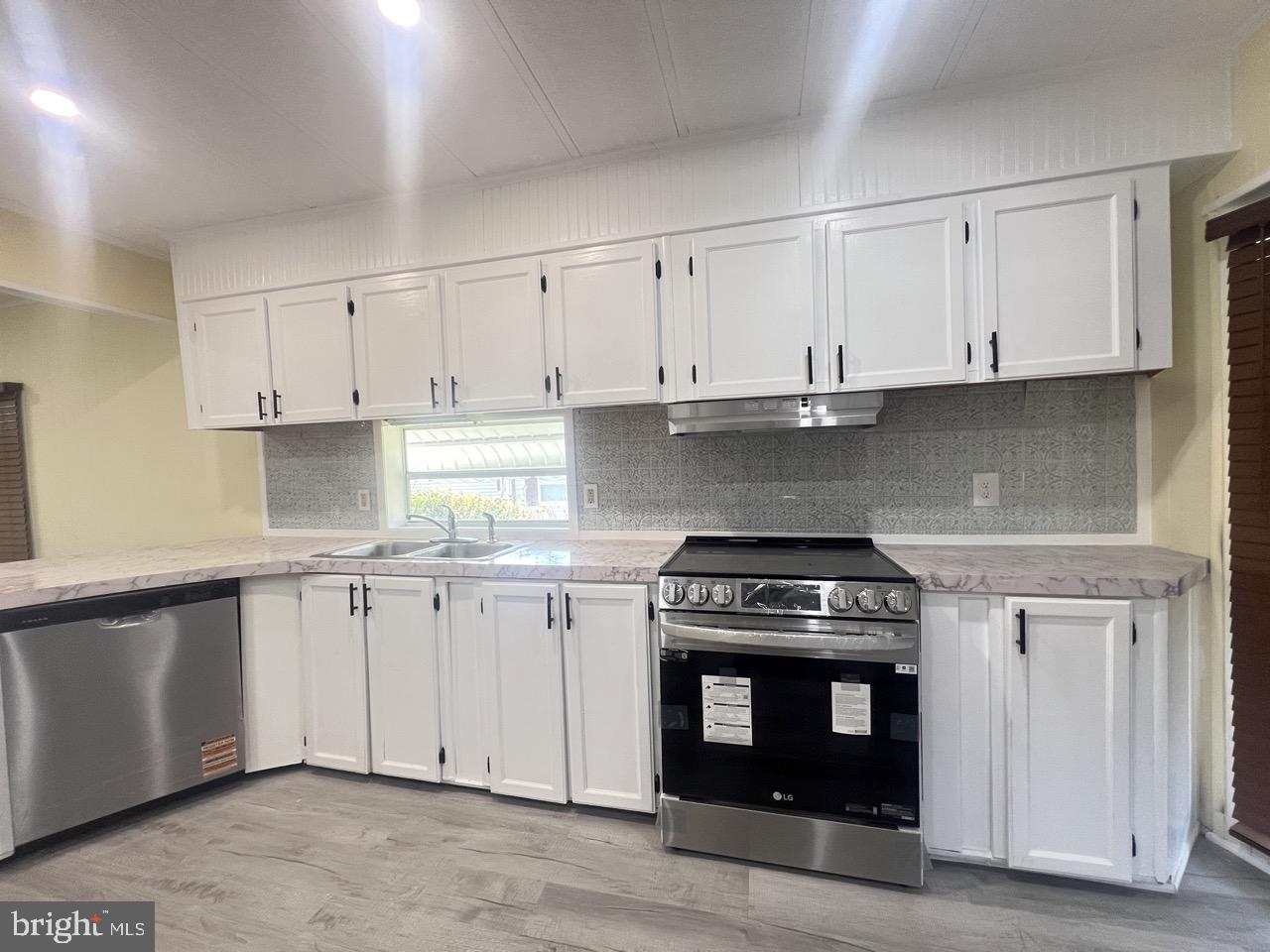 202 Mt Laurel Drive Ridgeley, WV 26753 - Photo 7 of 38 a kitchen with granite countertop white cabinets and stainless steel appliances