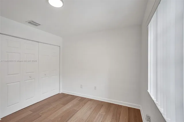 a bathroom with a granite countertop sink a toilet a mirror and bathtub
