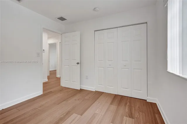 a view of house with a yard and palm trees