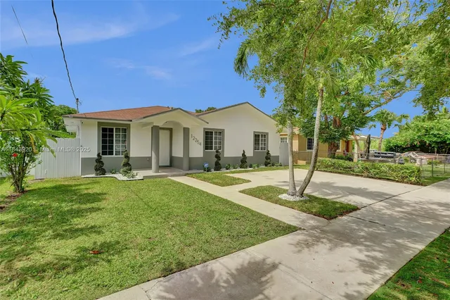 a front view of a house with a garden