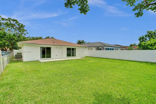 a view of a field of grass and trees