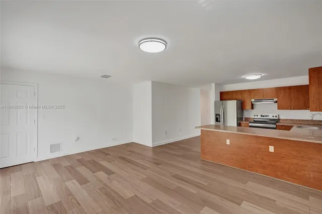 a view of room with window and hardwood floor