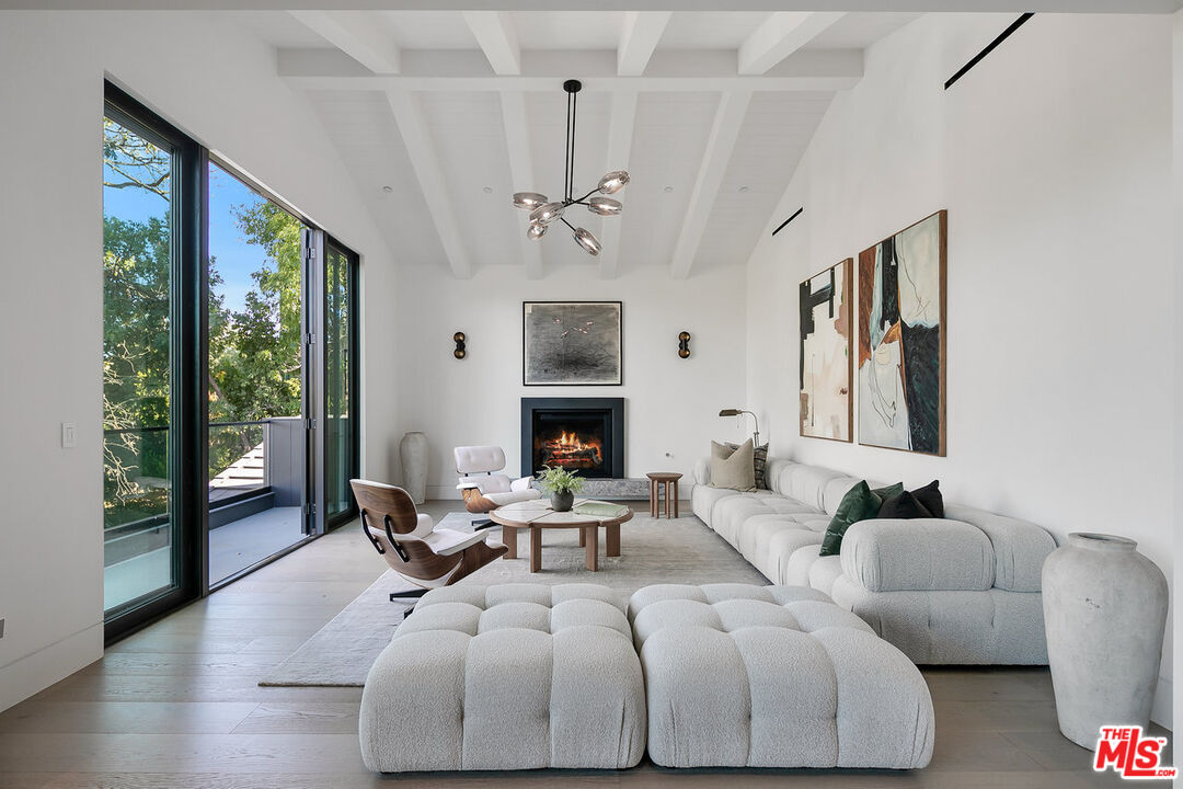 5376 Round Meadow Road Hidden Hills, CA 91302 - Photo 12 of 31 a living room with furniture fireplace and large windows