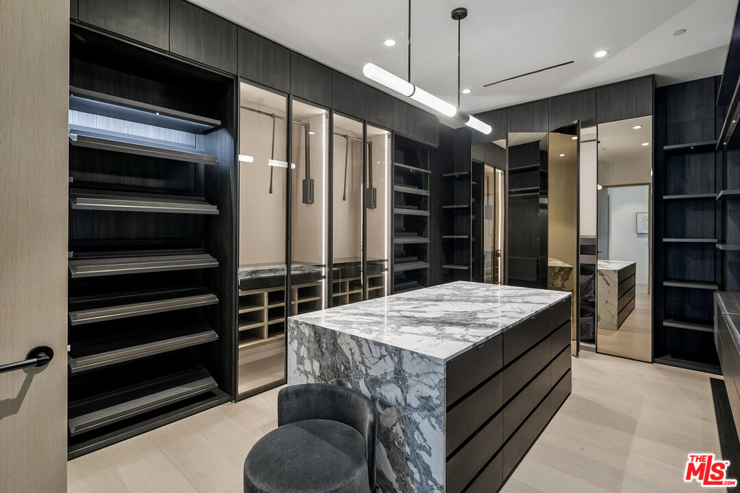 5376 Round Meadow Road Hidden Hills, CA 91302 - Photo 15 of 31 a kitchen with stainless steel appliances kitchen island granite countertop a refrigerator and a stove top oven