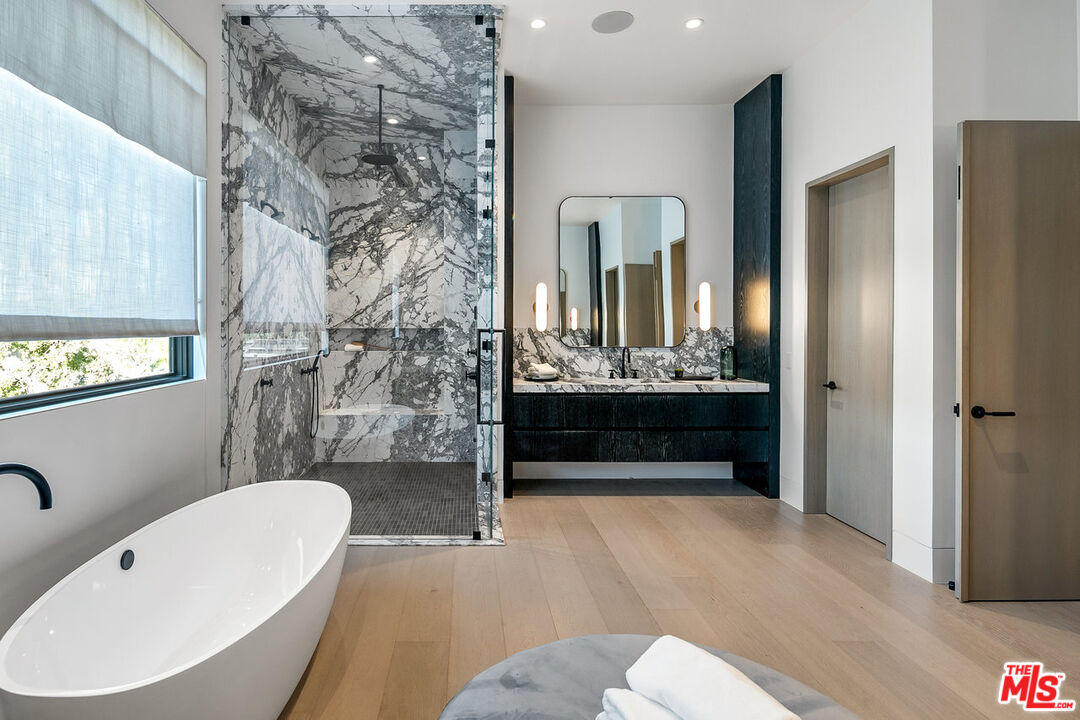 5376 Round Meadow Road Hidden Hills, CA 91302 - Photo 16 of 31 a bathroom with a bathtub sink and mirror