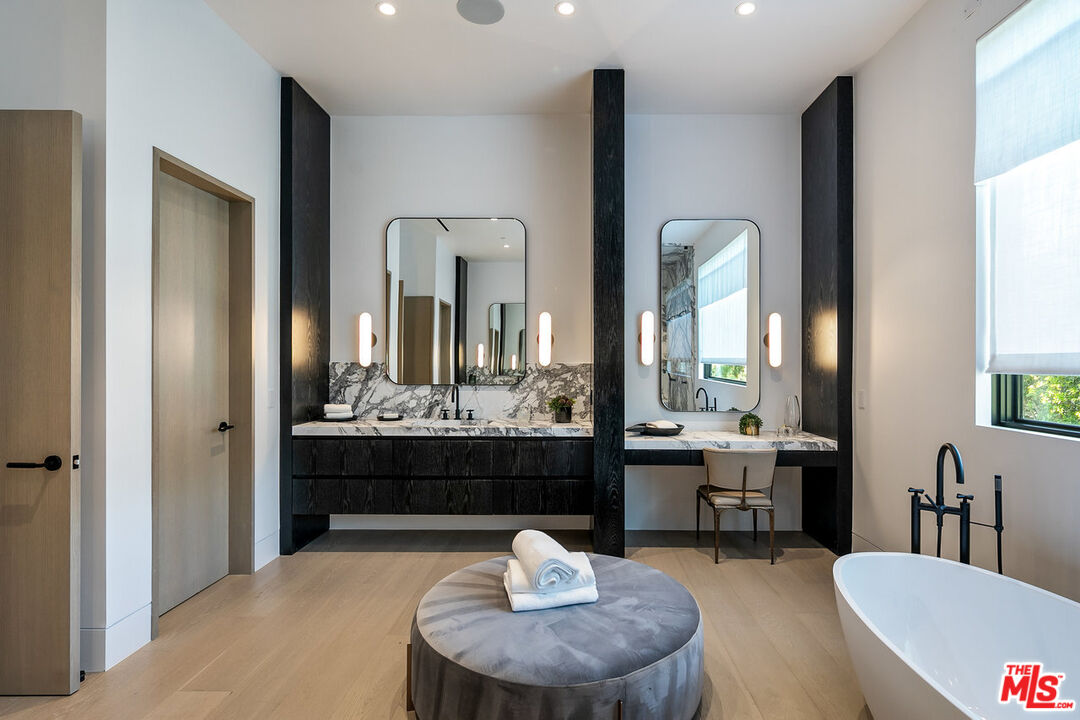 5376 Round Meadow Road Hidden Hills, CA 91302 - Photo 17 of 31 a room with a table chairs and a chandelier