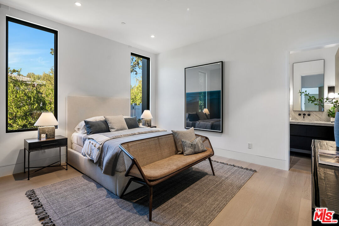 5376 Round Meadow Road Hidden Hills, CA 91302 - Photo 18 of 31 a bedroom with a bed and wooden floor