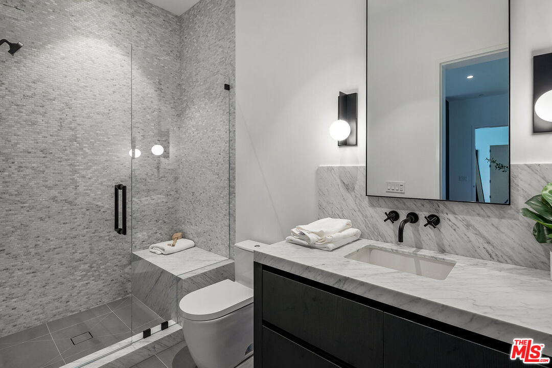 5376 Round Meadow Road Hidden Hills, CA 91302 - Photo 19 of 31 a bathroom with a sink and a mirror