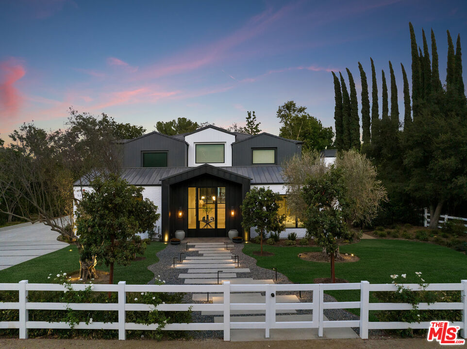 5376 Round Meadow Road Hidden Hills, CA 91302 - Photo 2 of 31 a front view of a house with a yard