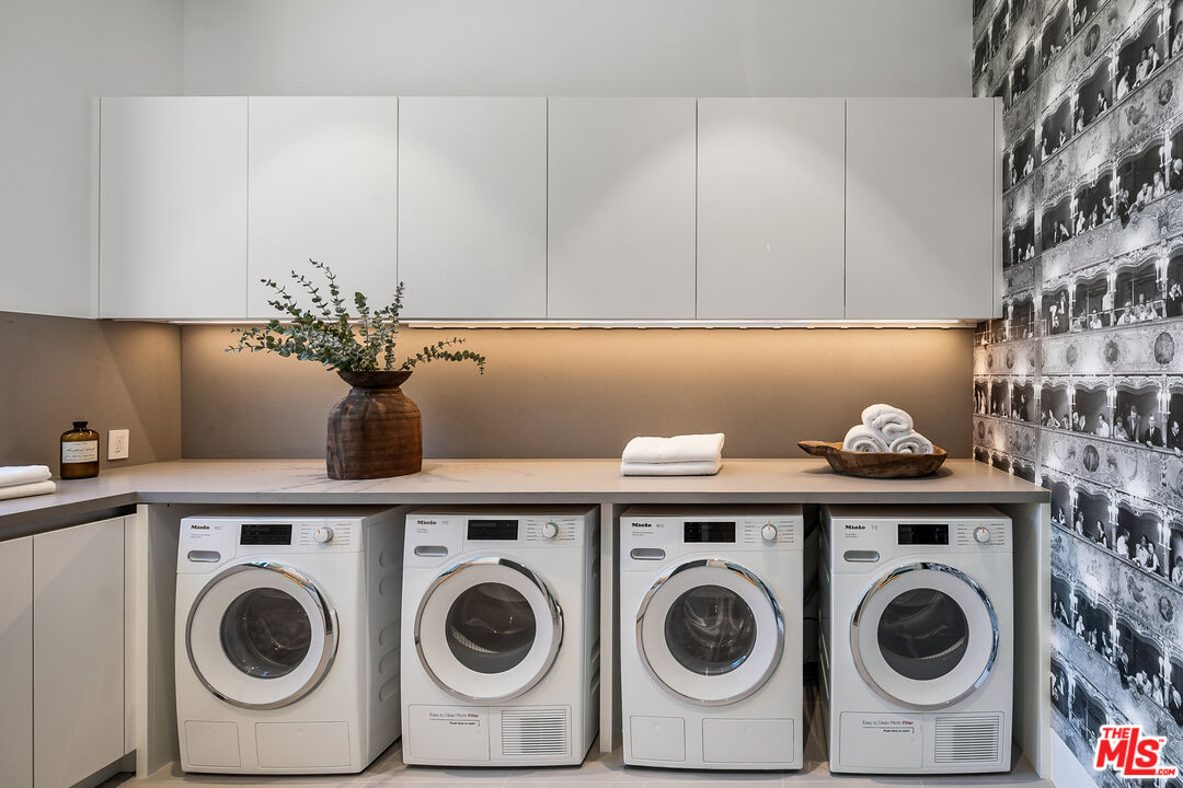 5376 Round Meadow Road Hidden Hills, CA 91302 - Photo 27 of 31 a view of storage and utility room with washer and dryer