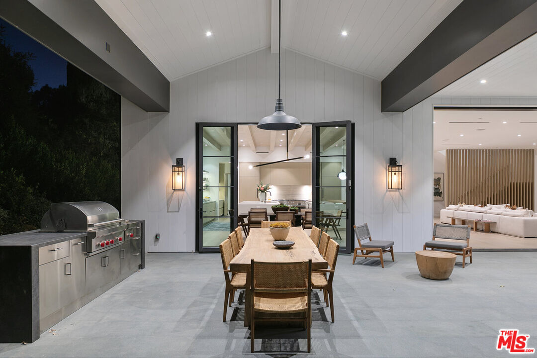 5376 Round Meadow Road Hidden Hills, CA 91302 - Photo 28 of 31 a living room with furniture and a chandelier
