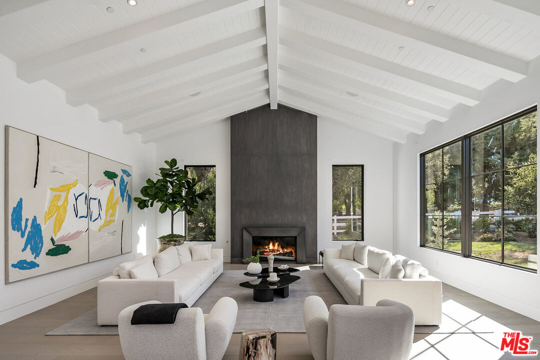 5376 Round Meadow Road Hidden Hills, CA 91302 - Photo 3 of 31 a living room with furniture and a fireplace