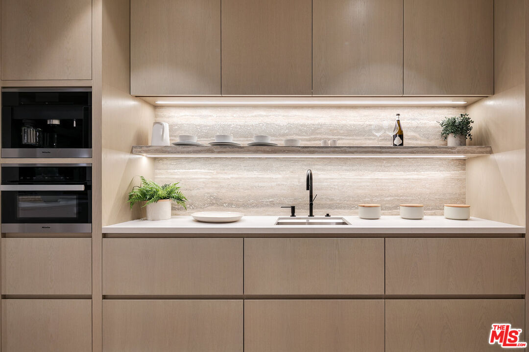 5376 Round Meadow Road Hidden Hills, CA 91302 - Photo 9 of 31 a kitchen with a sink and cabinets