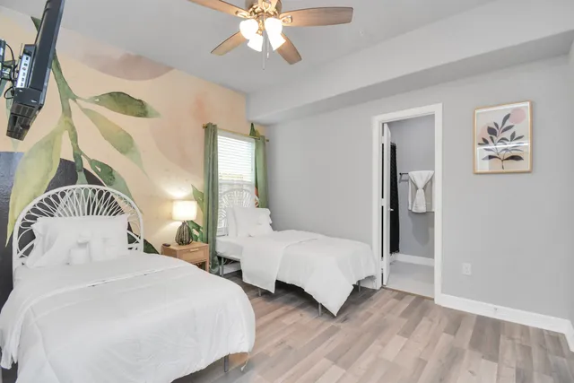 a bedroom with two beds and a chandelier