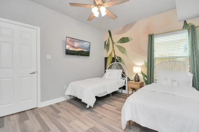 a bedroom with a bed and a chandelier