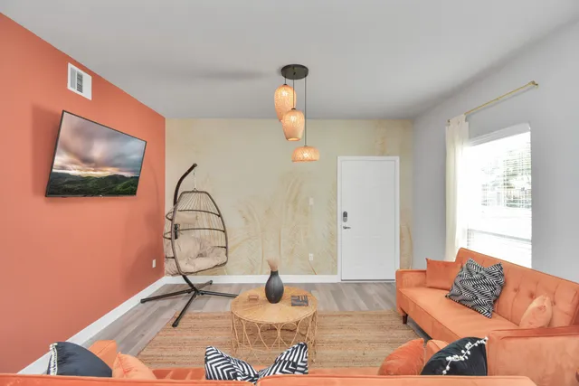 a living room with furniture a rug and a window