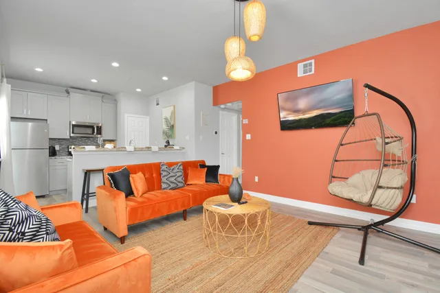 a living room with furniture and a wooden floor