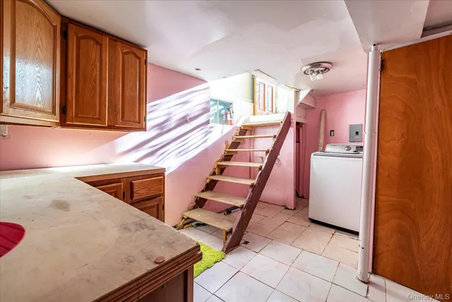 a view of a kitchen with furniture and stairs