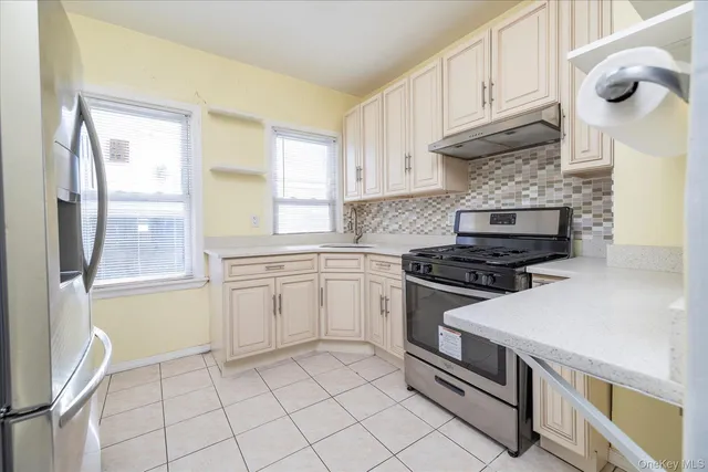 a kitchen with cabinets appliances and a window