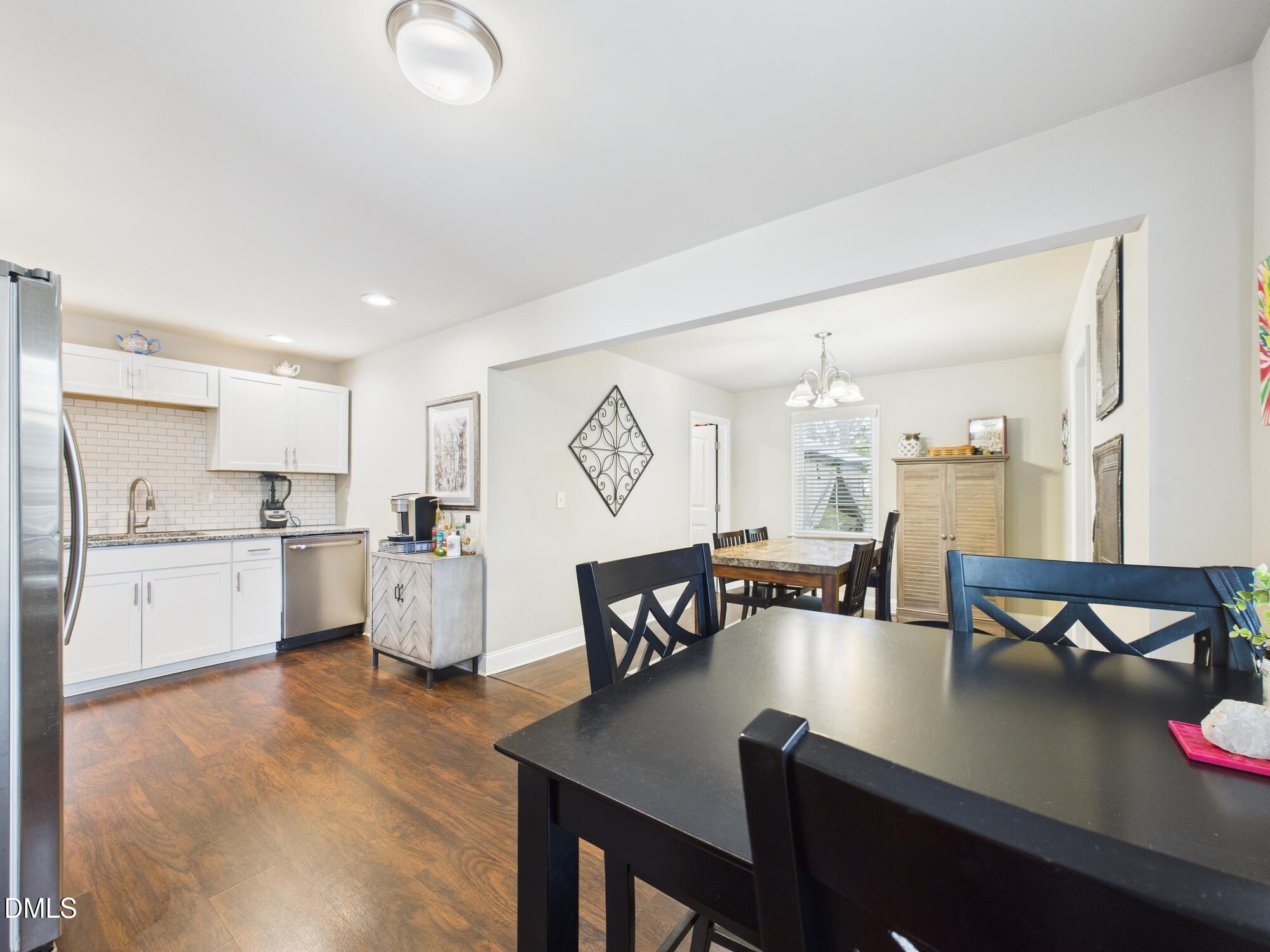 109 Blanchard Street Raleigh, NC 27603 - Photo 13 of 57 a large white kitchen with a table and chairs