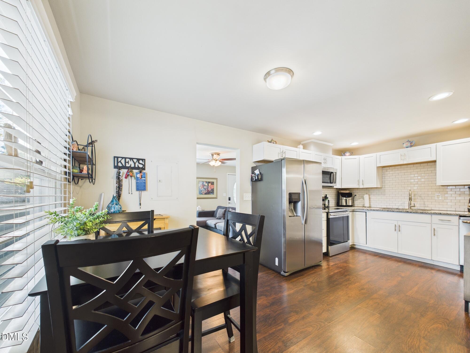 109 Blanchard Street Raleigh, NC 27603 - Photo 15 of 57 a view of a dining room with furniture and chandelier
