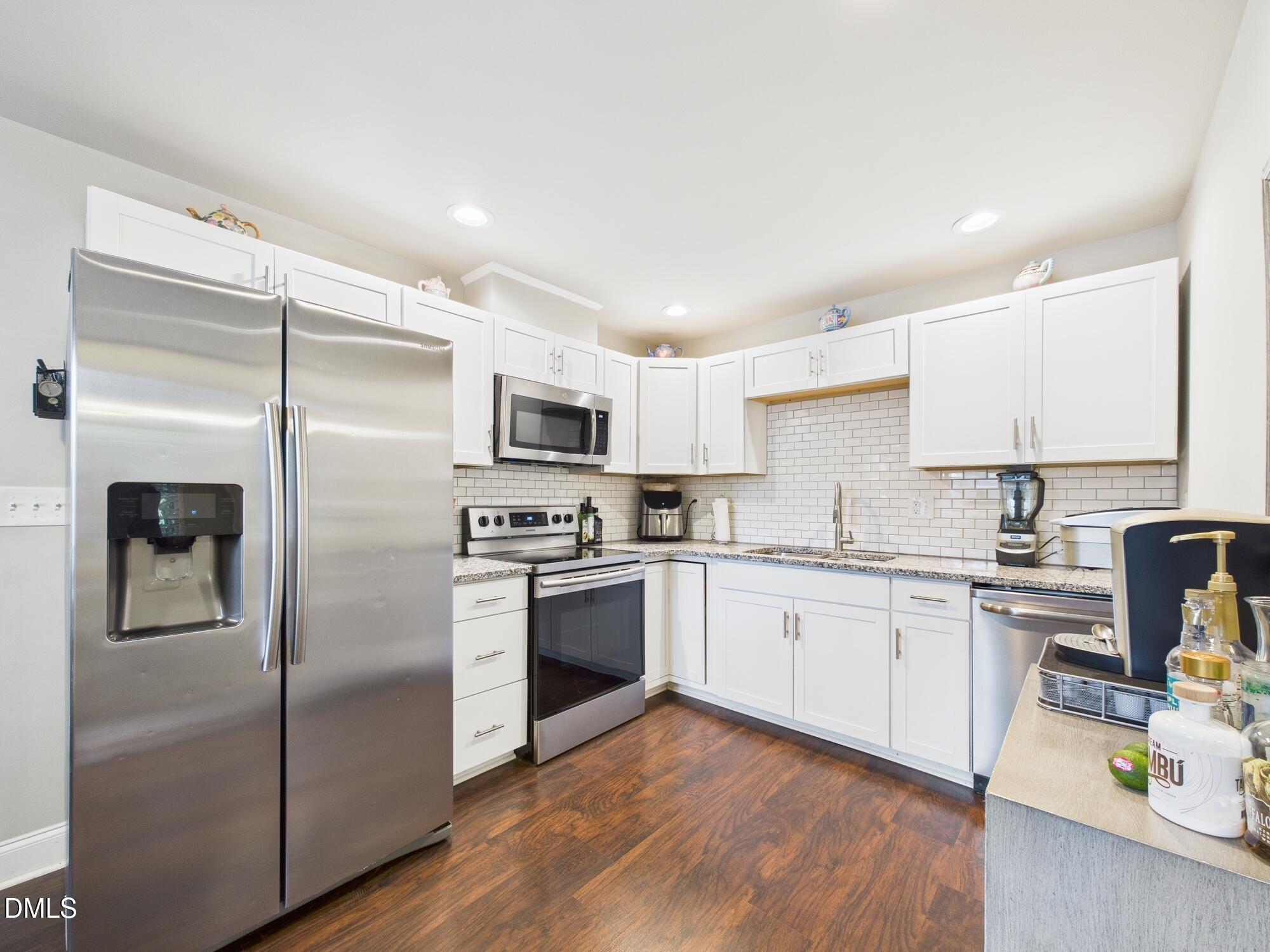 109 Blanchard Street Raleigh, NC 27603 - Photo 16 of 57 a kitchen with stainless steel appliances cabinets a sink and a center island
