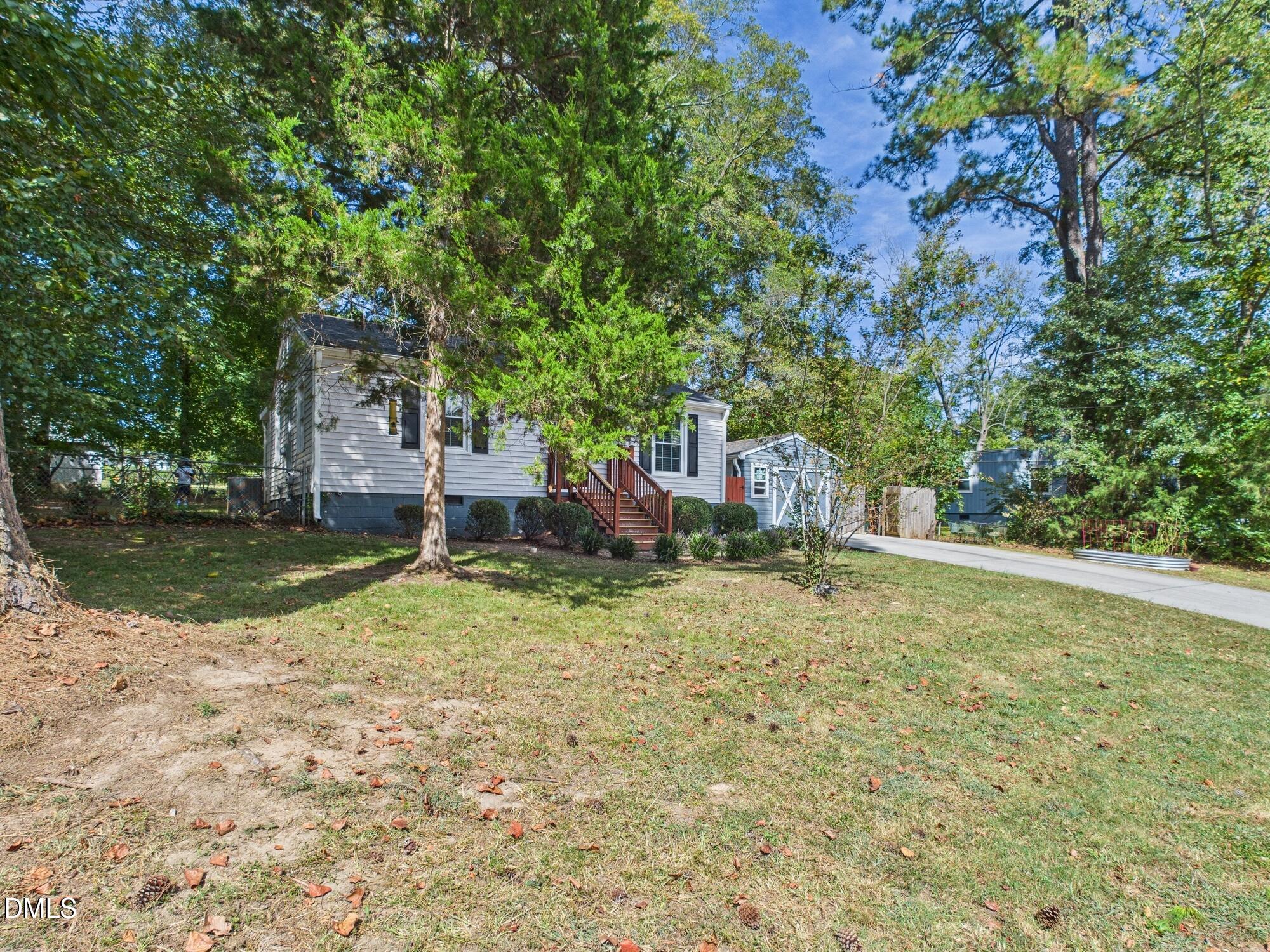 109 Blanchard Street Raleigh, NC 27603 - Photo 2 of 57 a backyard of a house with lots of green space