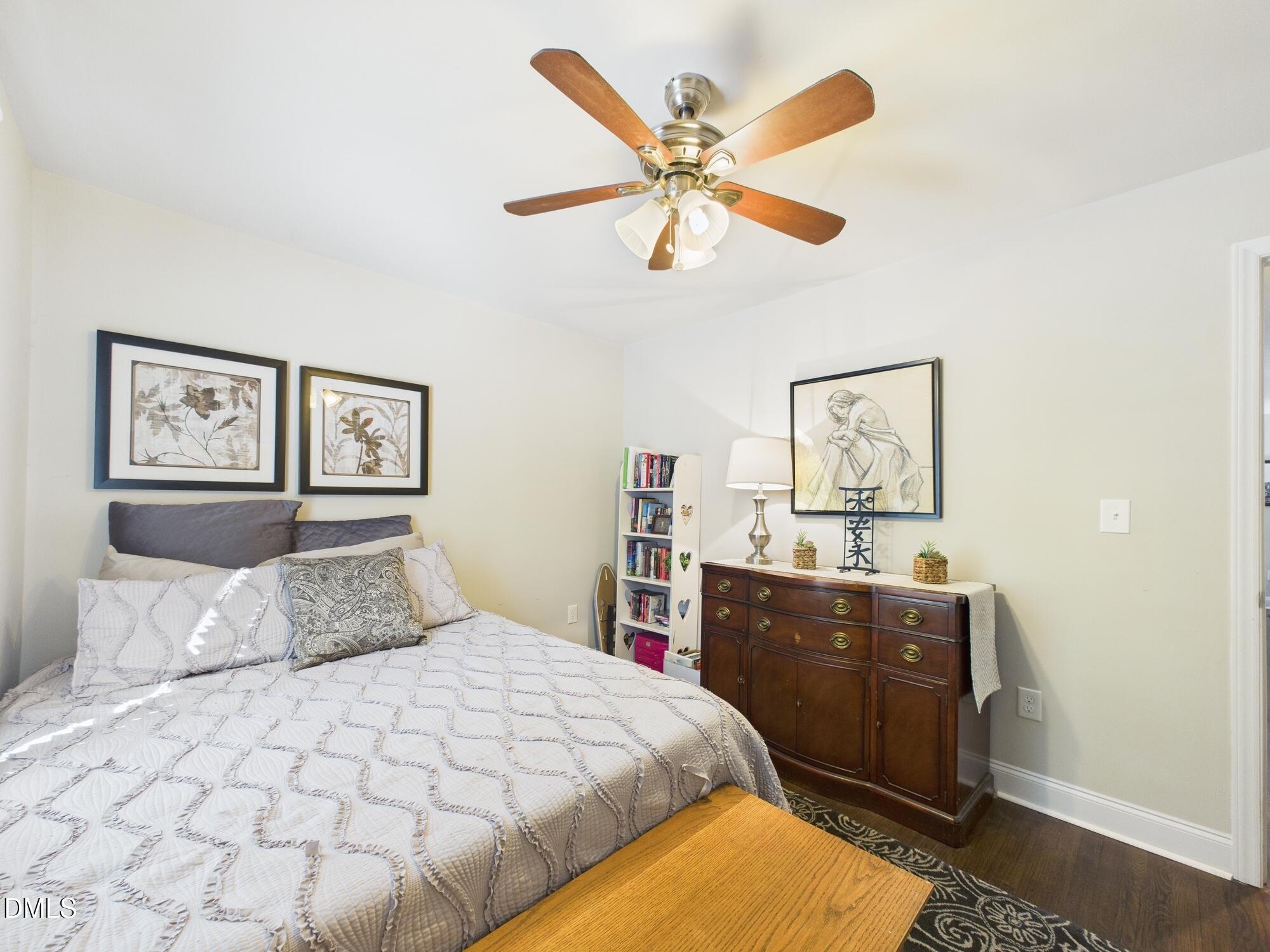 109 Blanchard Street Raleigh, NC 27603 - Photo 30 of 57 a bedroom with a large bed and a chandelier