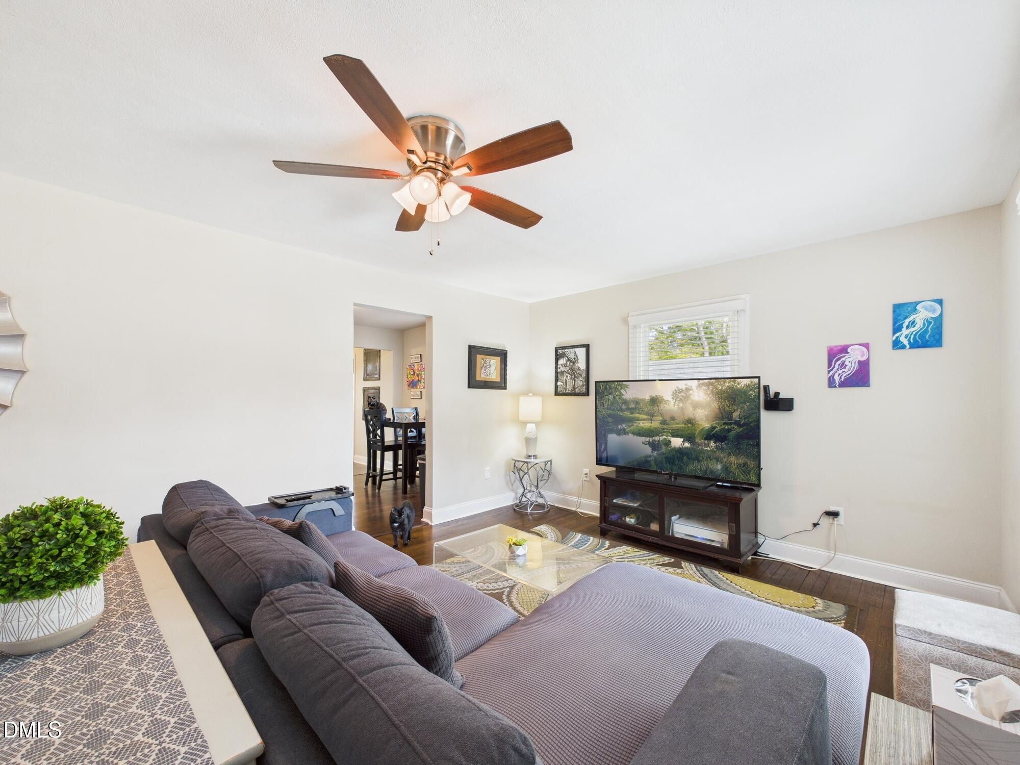 109 Blanchard Street Raleigh, NC 27603 - Photo 9 of 57 a living room with furniture and a flat screen tv