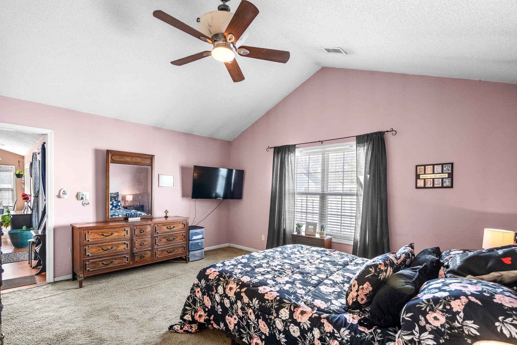 120 Point Break Drive Myrtle Beach, SC 29588 - Photo 25 of 38 Bedroom with multiple windows, a textured ceiling, light colored carpet, lofted ceiling, and a ceiling fan