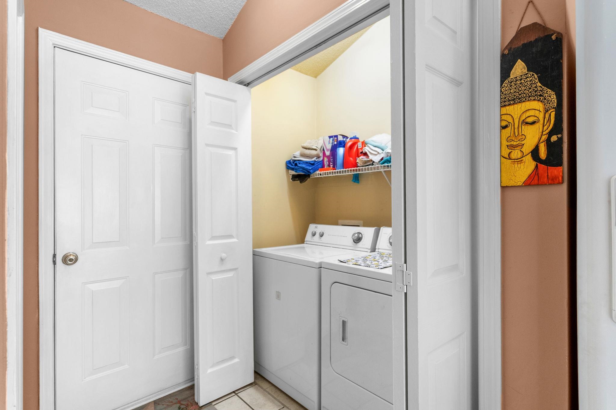 120 Point Break Drive Myrtle Beach, SC 29588 - Photo 33 of 38 Washroom with washing machine and dryer, a textured ceiling, and light tile patterned floors