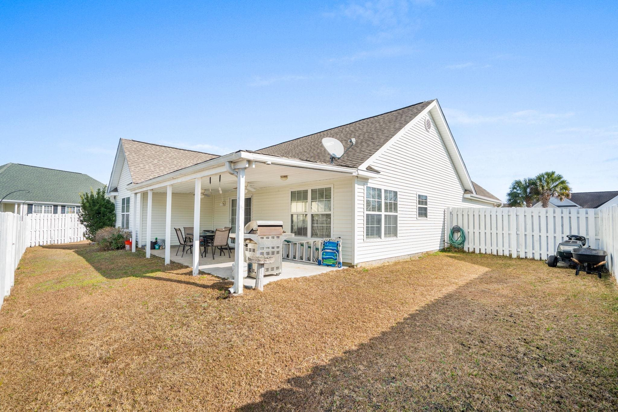 120 Point Break Drive Myrtle Beach, SC 29588 - Photo 34 of 38 Back of house with a fenced backyard, a shingled roof, and a patio area
