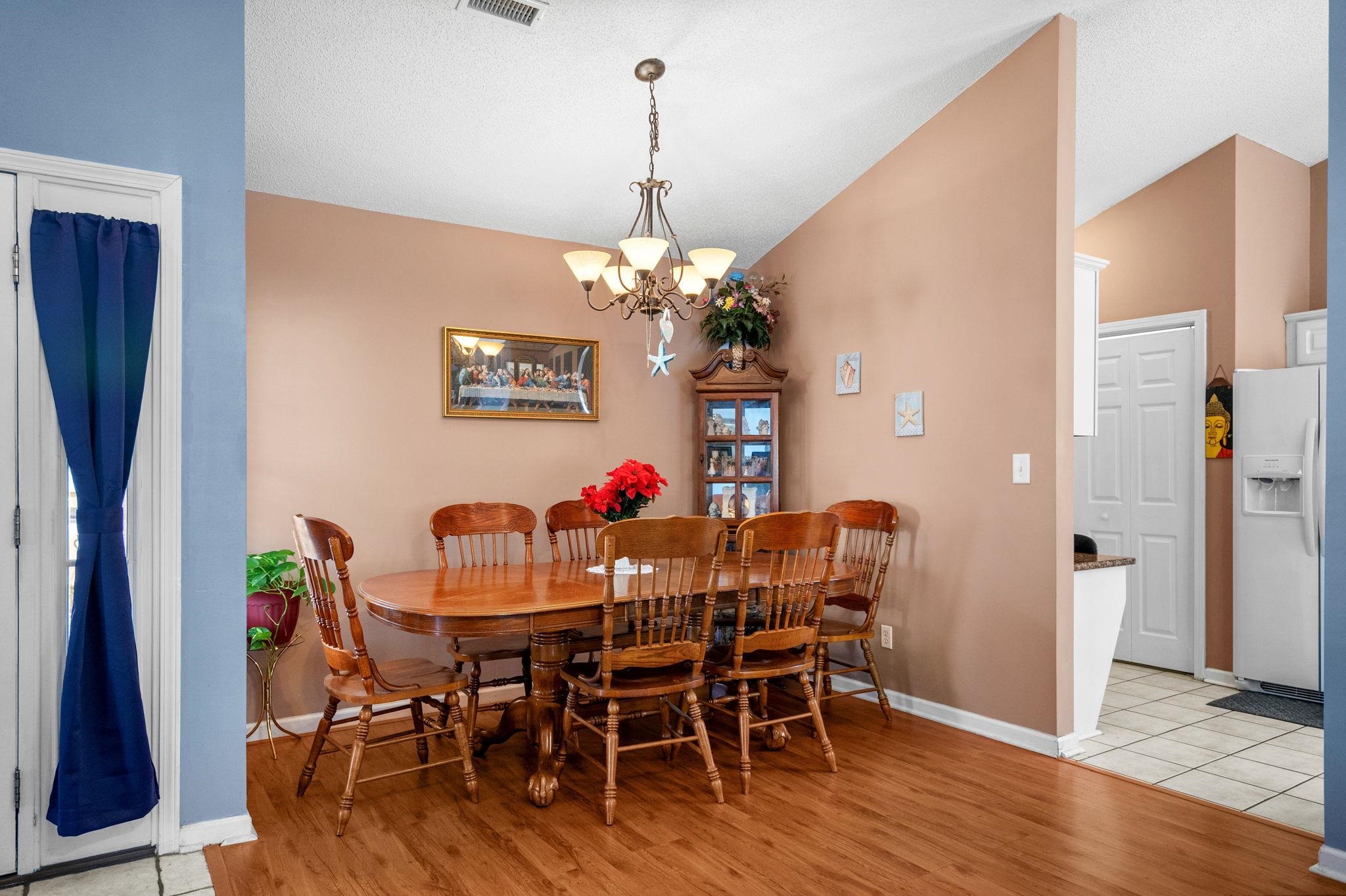 120 Point Break Drive Myrtle Beach, SC 29588 - Photo 9 of 38 Dining area featuring lofted ceiling, light wood-style floors, and a chandelier