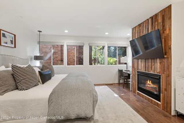 a bedroom with a bed and a fireplace