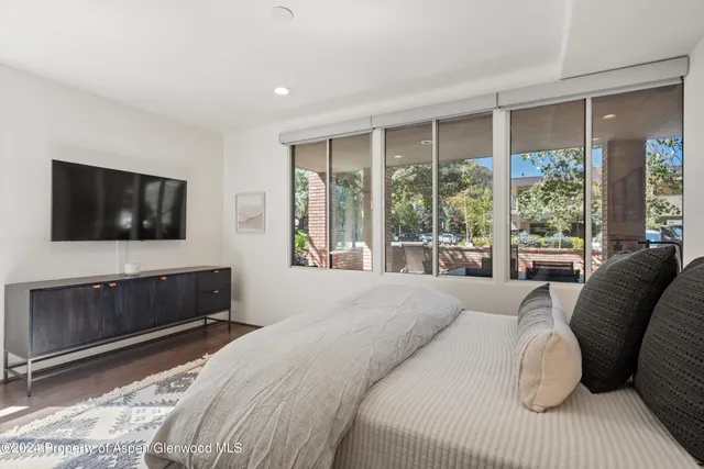 a bedroom with a bed and a television