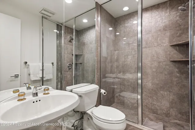 a bathroom with a sink toilet and shower