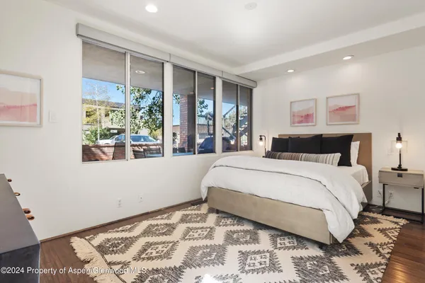 a bedroom with a large window and a bed