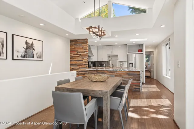 a view of a dining room with furniture and wooden floor