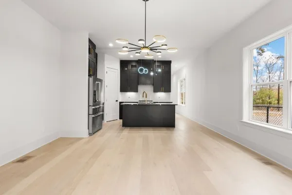 a living room with furniture and a chandelier