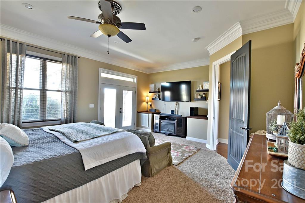 3822 Zebulon Williams Road Monroe, NC 28110 - Photo 15 of 36 a bedroom with a bed and glass walk in closet