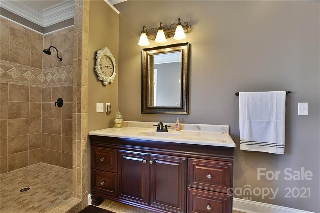 3822 Zebulon Williams Road Monroe, NC 28110 - Photo 17 of 36 a bathroom with a sink a mirror and shower