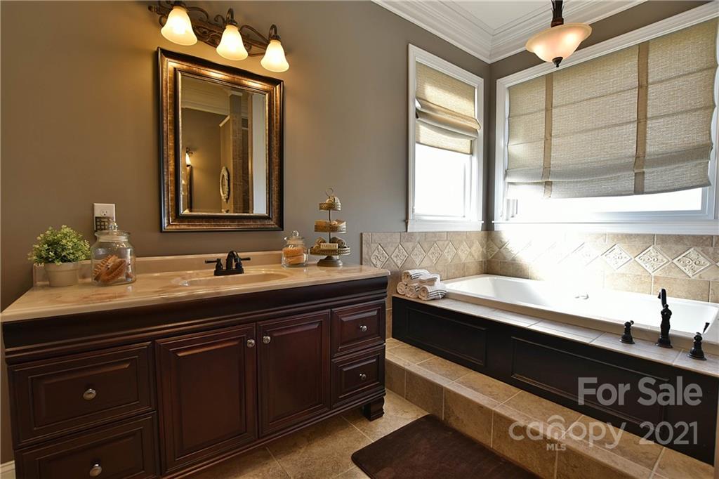 3822 Zebulon Williams Road Monroe, NC 28110 - Photo 18 of 36 a bathroom with a sink and a mirror