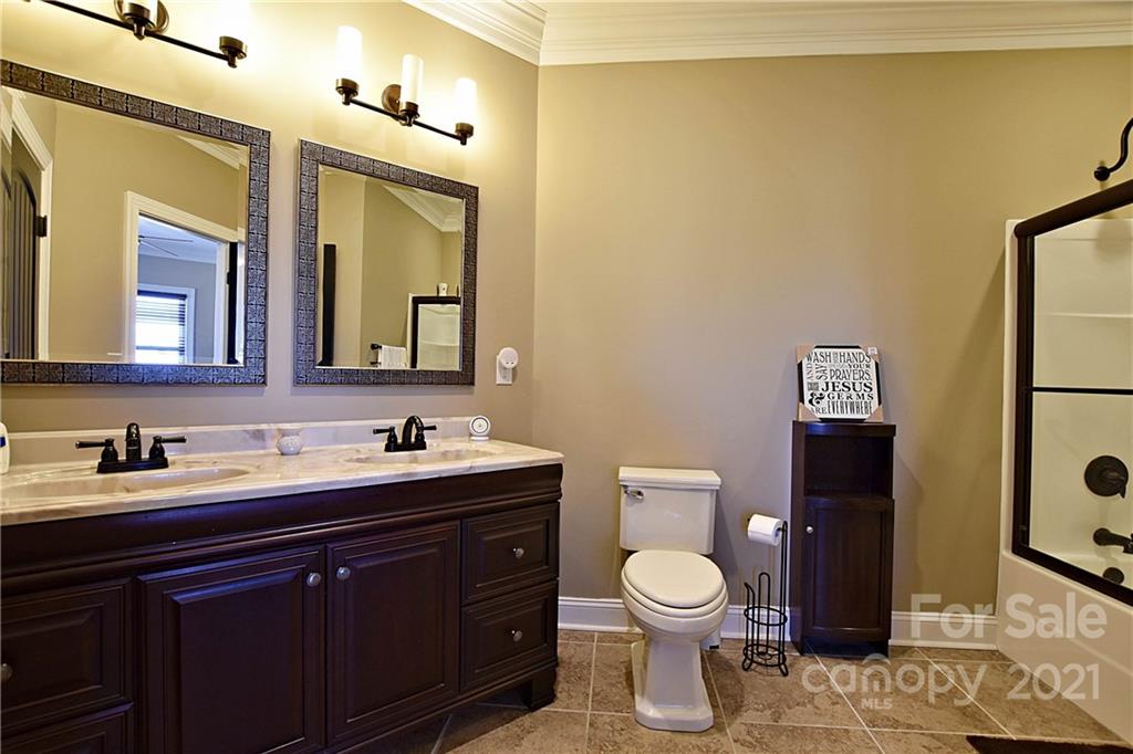 3822 Zebulon Williams Road Monroe, NC 28110 - Photo 22 of 36 a bathroom with a toilet sink and mirror
