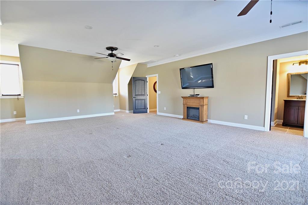 3822 Zebulon Williams Road Monroe, NC 28110 - Photo 28 of 36 a view of a livingroom with furniture and a flat screen tv