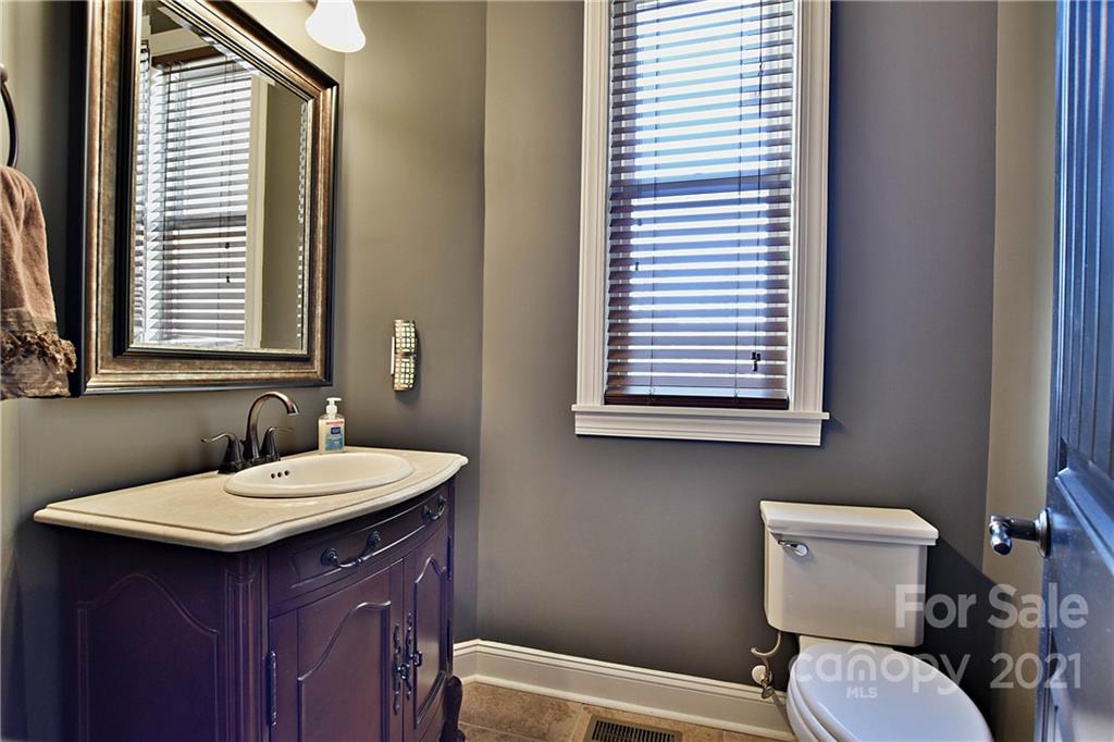 3822 Zebulon Williams Road Monroe, NC 28110 - Photo 31 of 36 a bathroom with a toilet a sink and a mirror