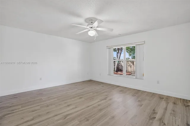 a view of an empty room and wooden floor
