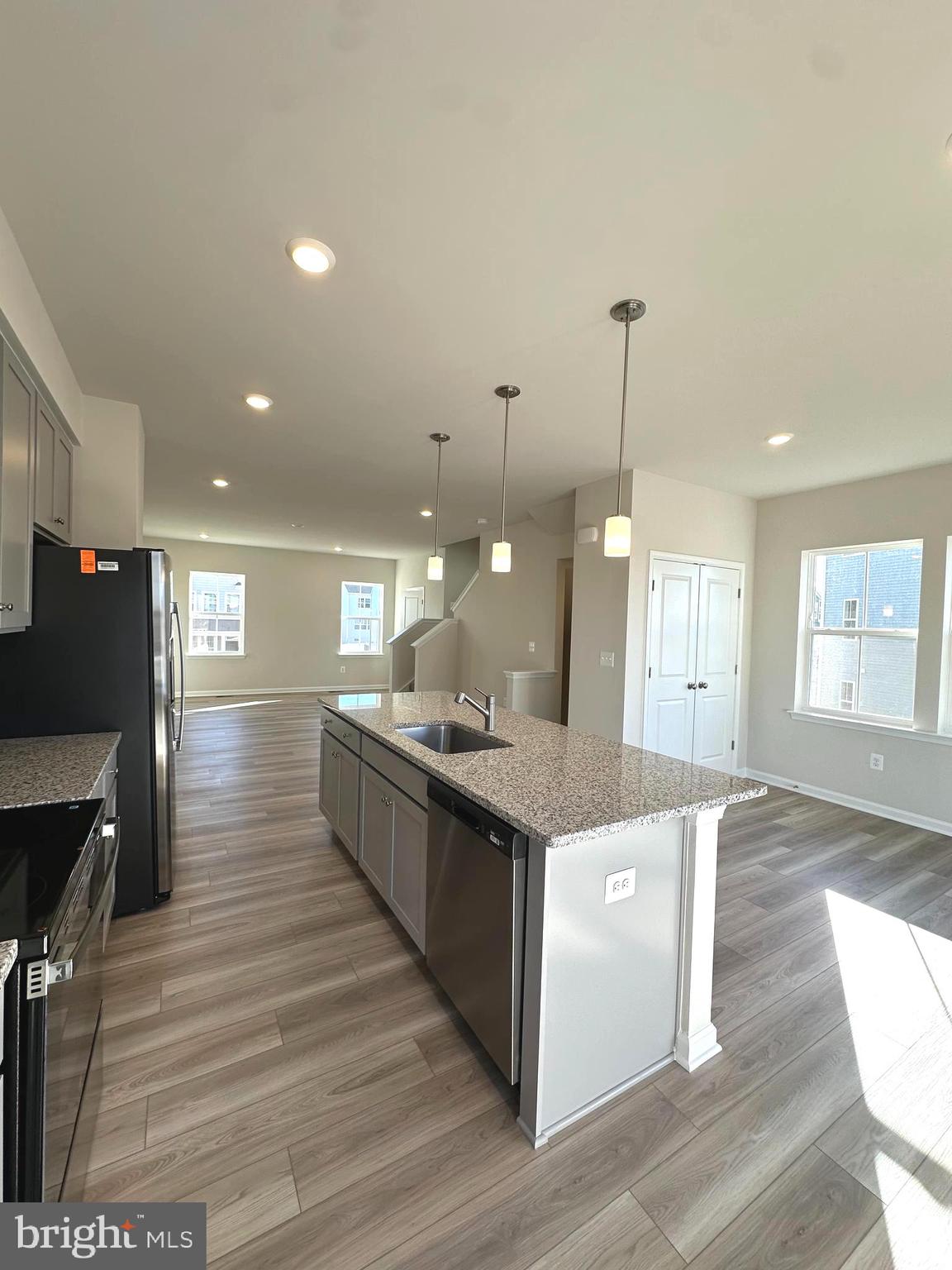 317 Short Br Drive Ranson, WV 25438 - Photo 14 of 41 a large kitchen with stainless steel appliances kitchen island a large counter top and a wooden floors