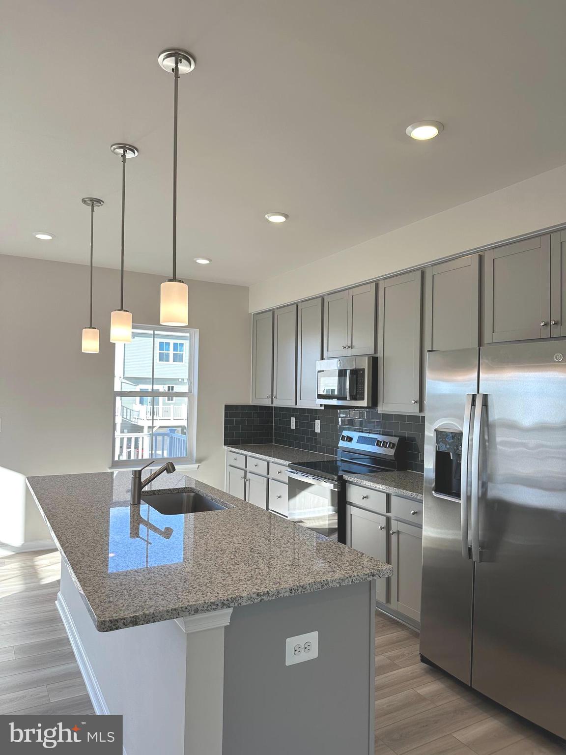 317 Short Br Drive Ranson, WV 25438 - Photo 17 of 41 a kitchen with stainless steel appliances granite countertop a sink a stove and a wooden floors